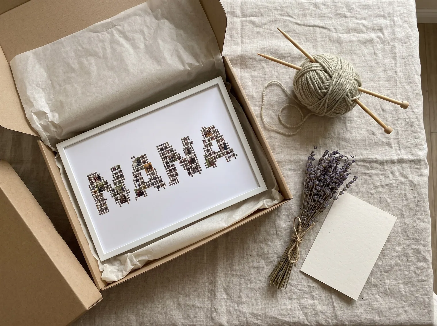 Flat lay of the NANA collage in a white frame in a gift box with yarn, knitting needles, lavender and a blank card